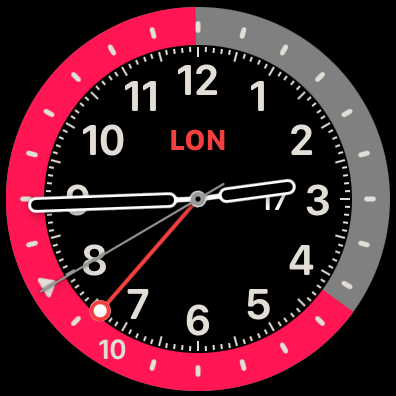 Apple Watch showing 2:44 p.m. in Los Angeles, 10:44 p.m. in London. You infer that pink is night because it is so long, or from the triangle that still marks midnight. Note that the GMT hand tracks Los Angeles time (currently UTC−8), but with midnight on top, so UTC midnight is at the eight o’clock marker.
